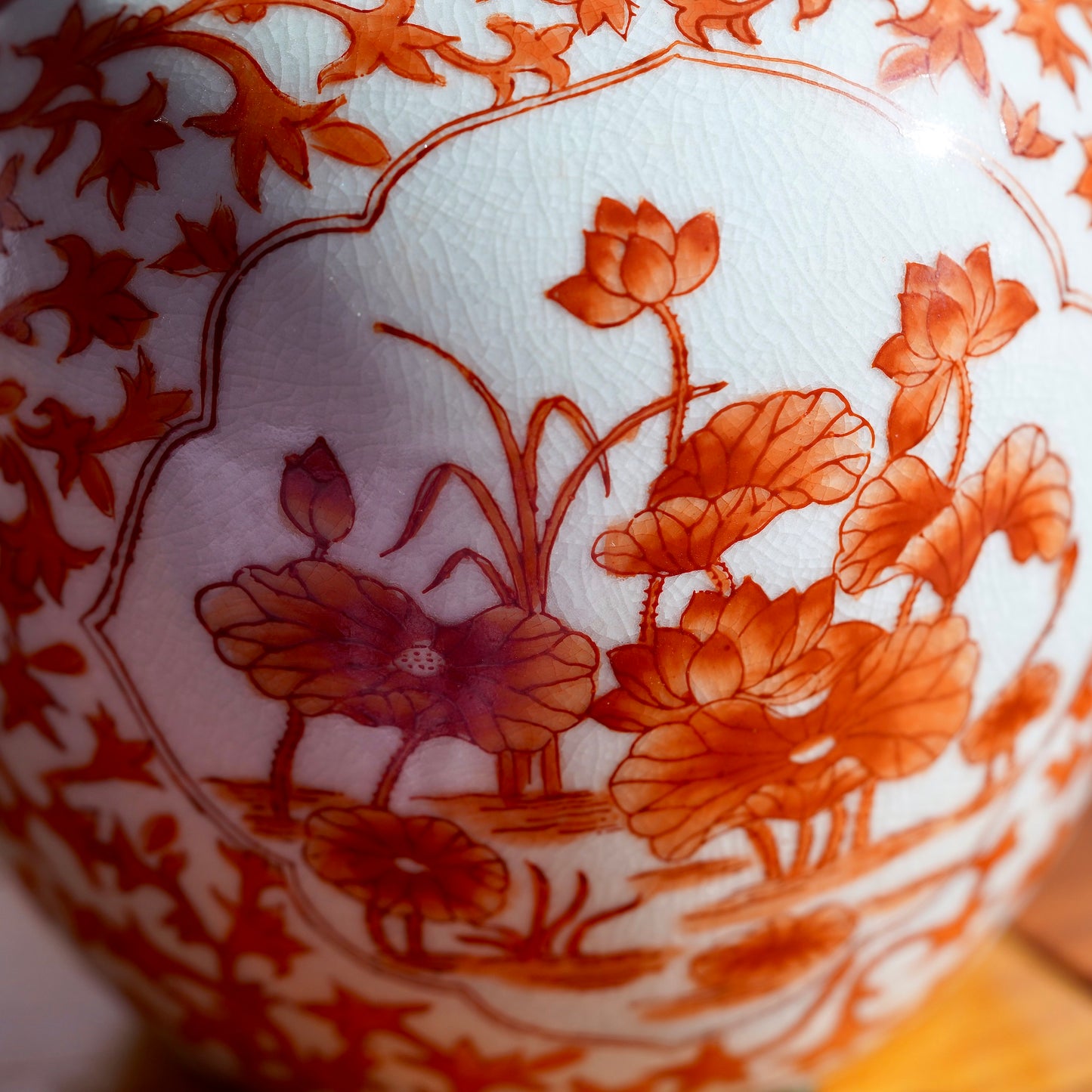 Close up detail shot of orange flowers handpainted on vintage Japanese porcelain vase.