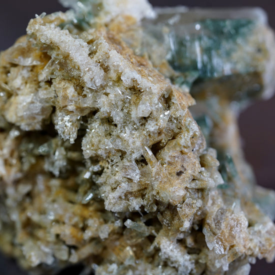 Macro shot of mini double terminated crystals on bottom of green Himalayan Quartz crystal cluster