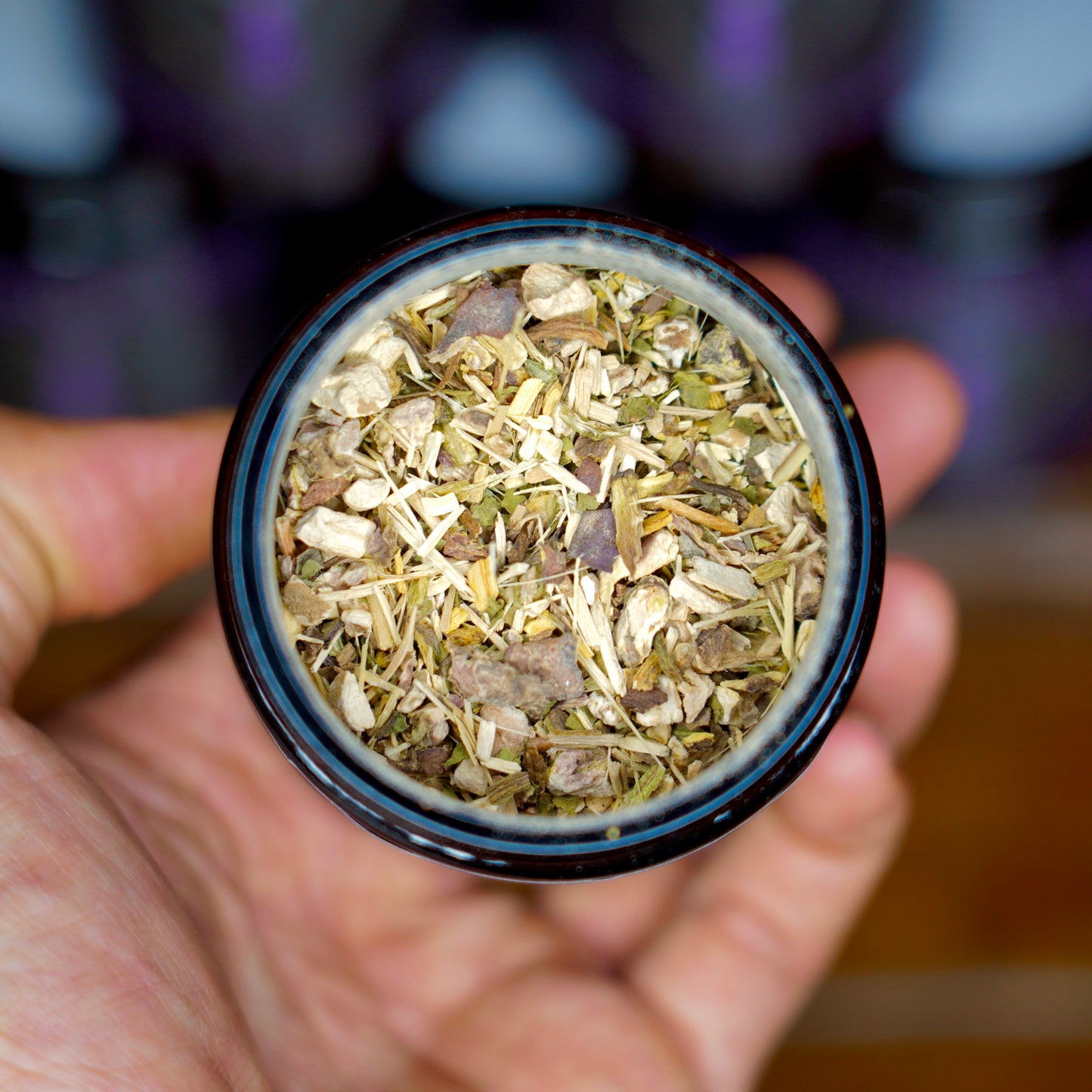 Adrenal Revive Herbal Tea Close Up Shot of Herbs in Jar Held in Hand