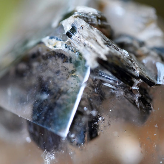 Detailed macro photo of Muscovite and Biotite Mica on tip pf polished Quartz tower